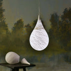 Illuminated Modern Natural Marble Teardrop Pendant Light in Artistic Still Life Setting