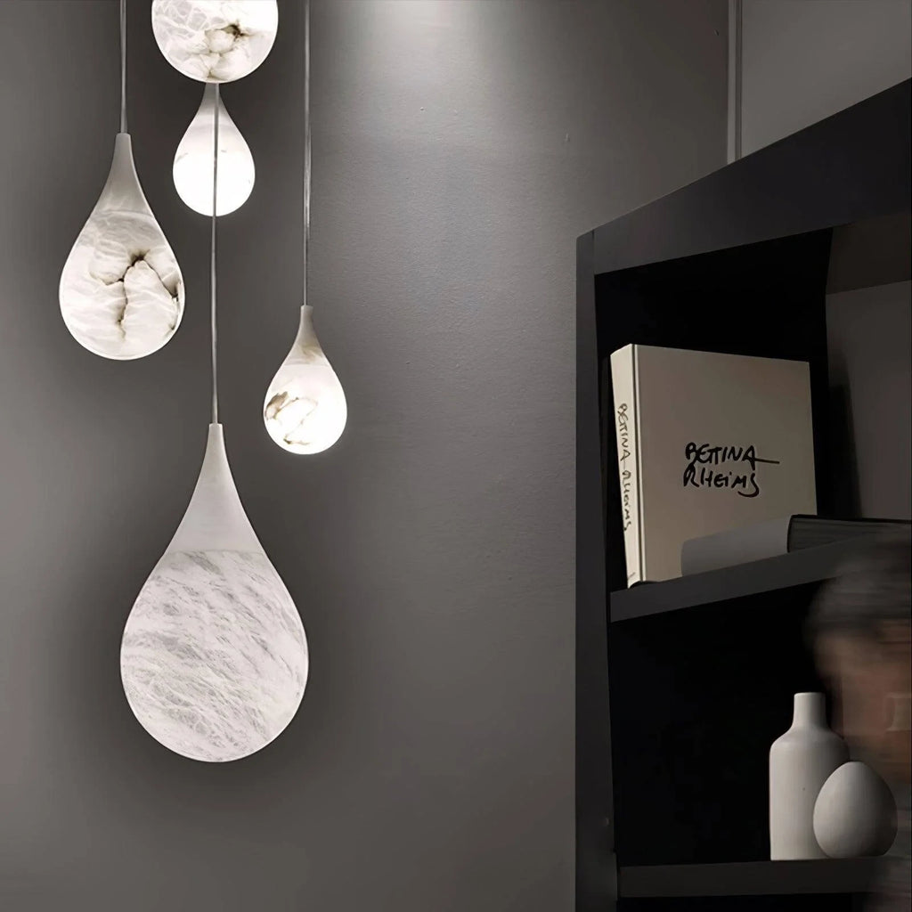 Illuminated Cluster of Modern Natural Marble Teardrop Pendant Lights Studio Shot