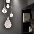 Illuminated Cluster of Modern Natural Marble Teardrop Pendant Lights Studio Shot