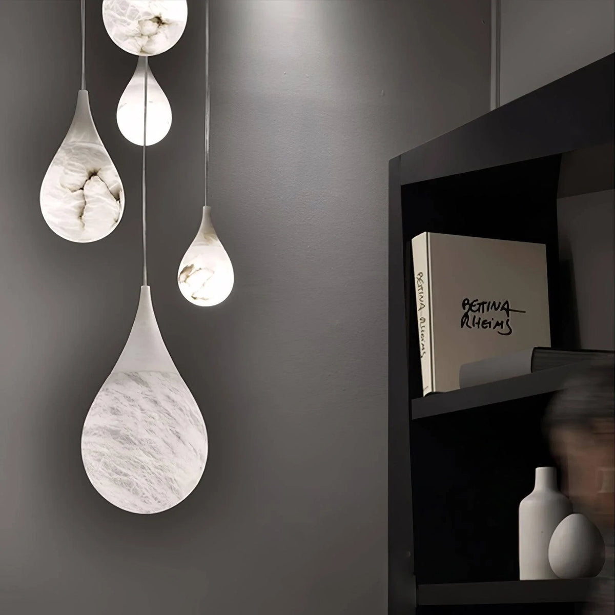 Illuminated Cluster of Modern Natural Marble Teardrop Pendant Lights Studio Shot