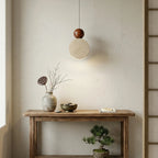 Wabi Sabi Travertine Pendant Lamp Over Wooden Console Table