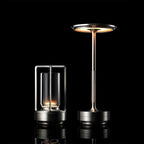 Pair of Modern Brass Cordless Table Lamp and Glass Cylinder Lamp Studio Display on Black Background