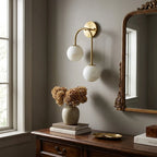 Modern Asymmetrical Globe Wall Sconce Over Console Table