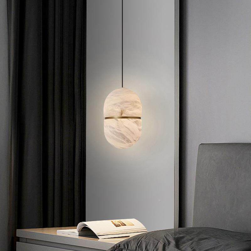 Velo Capsule Alabaster Pendant Lamp glowing above bedside table minimalist grey bedroom