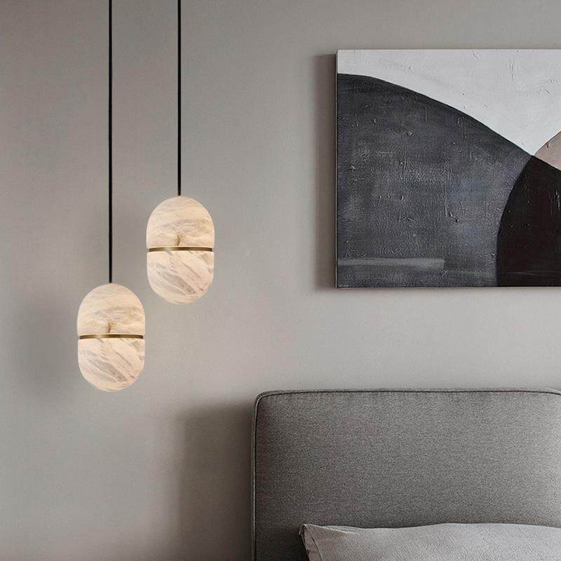 Pair of Velo alabaster pendant lights above grey bedside bed modern bedroom decor