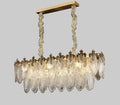 Illuminated Modern Antique Brass and Amber Feather Wave Art Glass Linear Chandelier Studio Shot