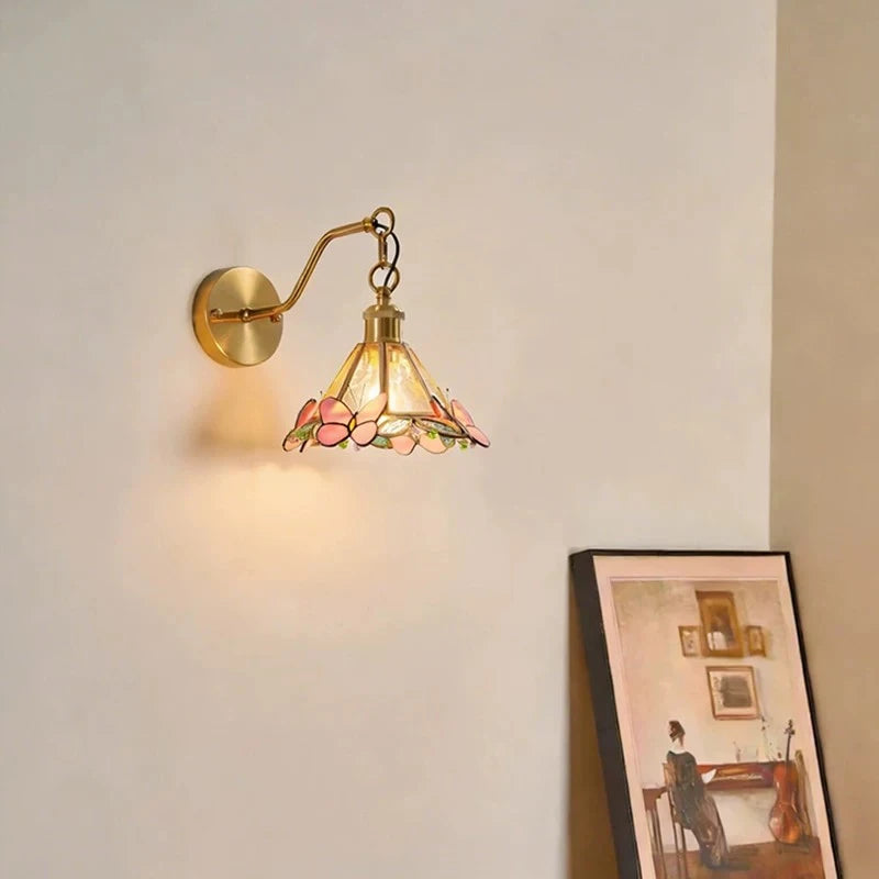 Traditional Brass Butterfly Wall Sconce Against Accent Wall