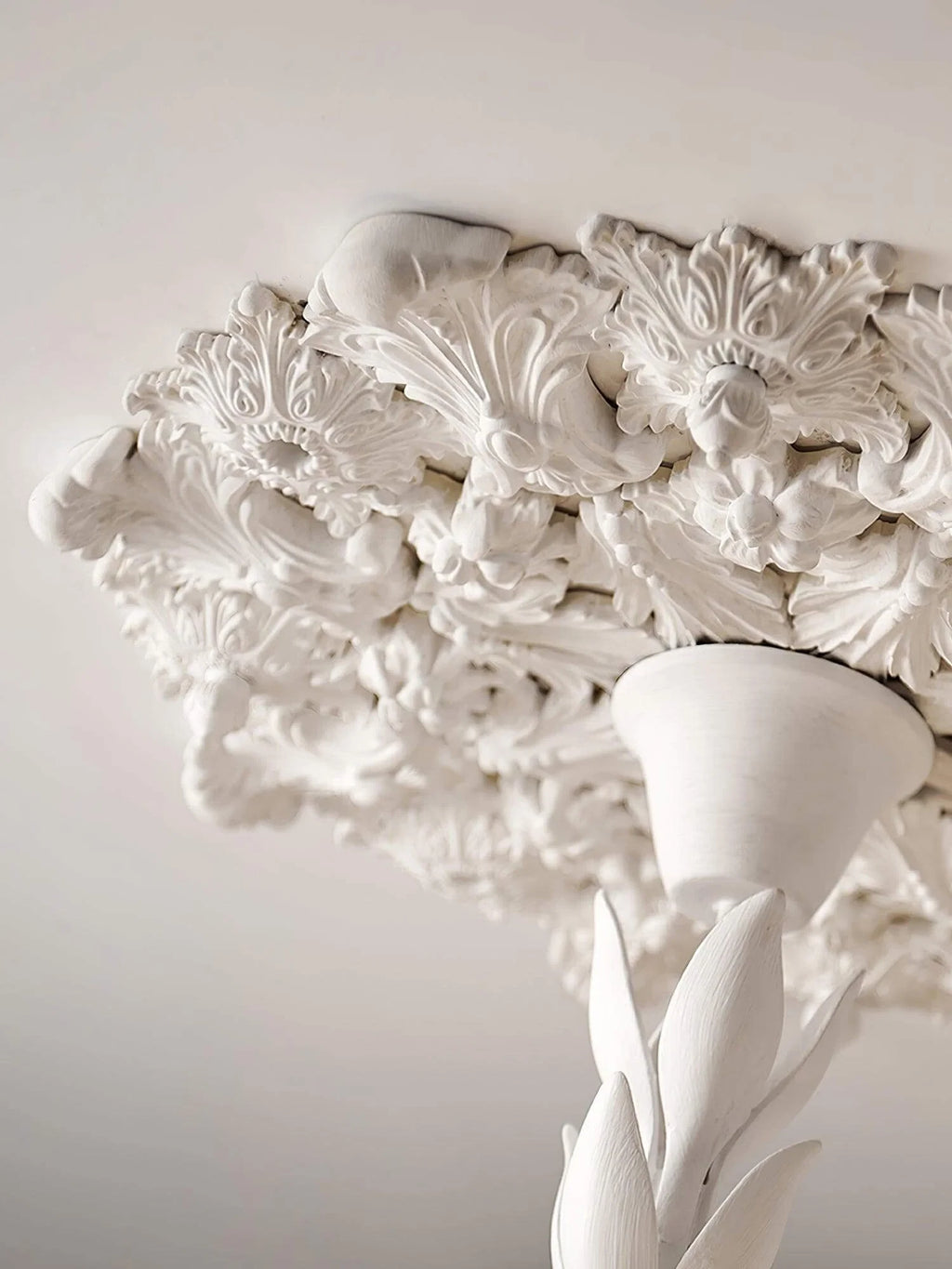 Close Up View of Carved White Petals and Chandelier Top Structure